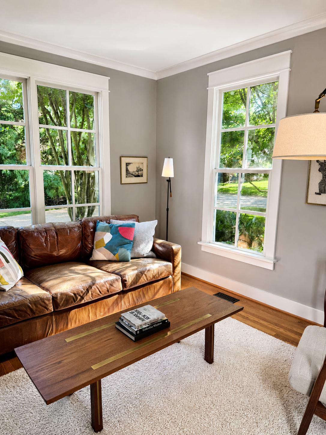 Living room with tall windows and leather sofa