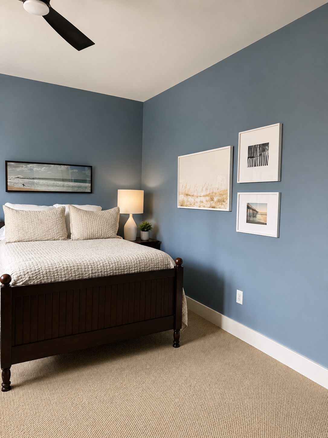 Mid-level bedroom showing coastal gallery wall and bedside detail